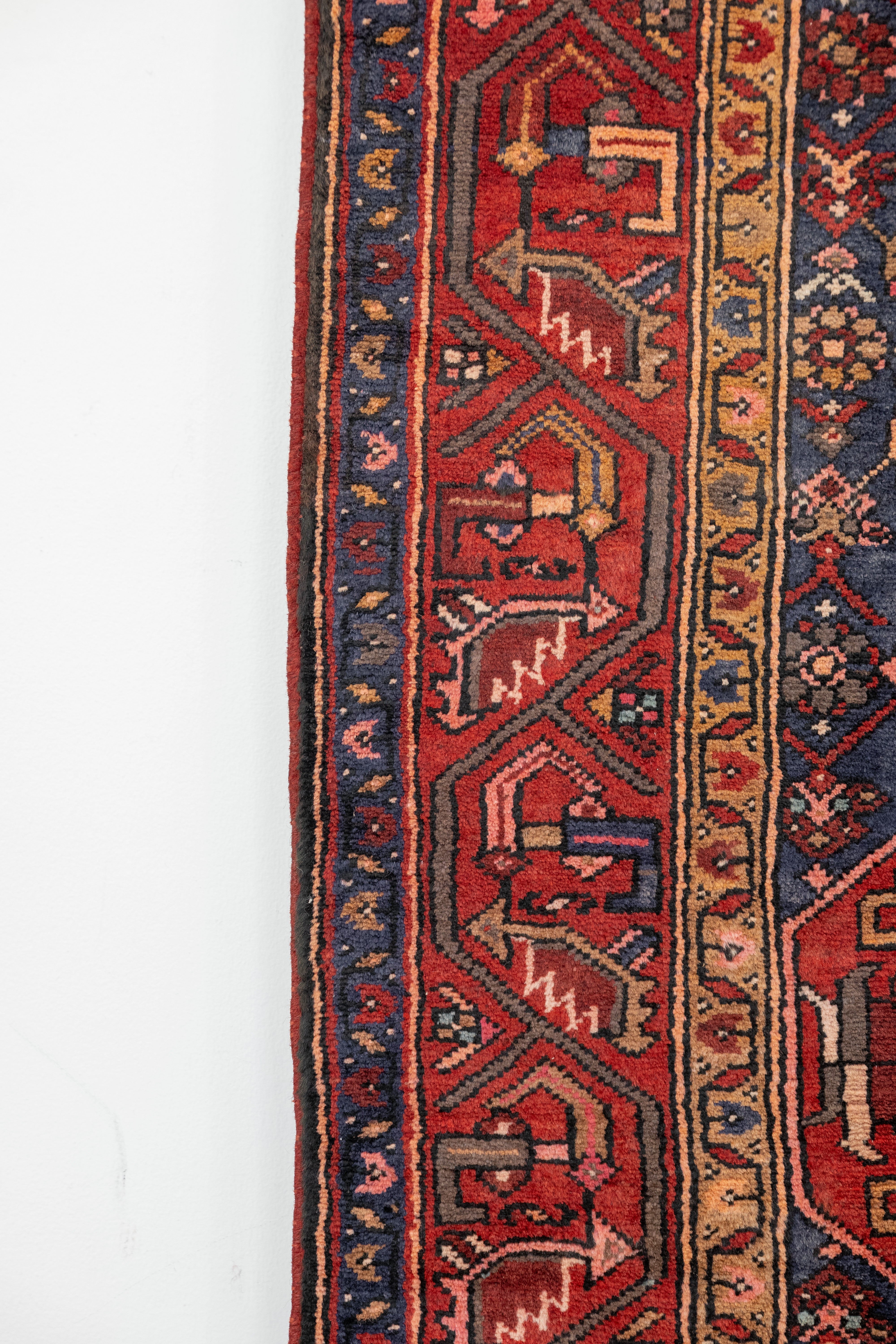 Close-up of a red and blue patterned rug on a white background